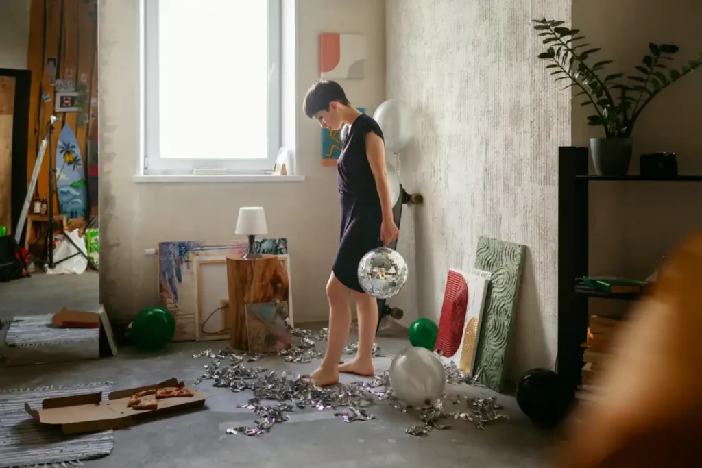 Teenager cleaning room to reduce hangover effect